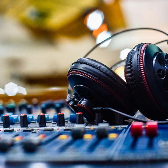 an image of some headphones resting on a DJ's mixer