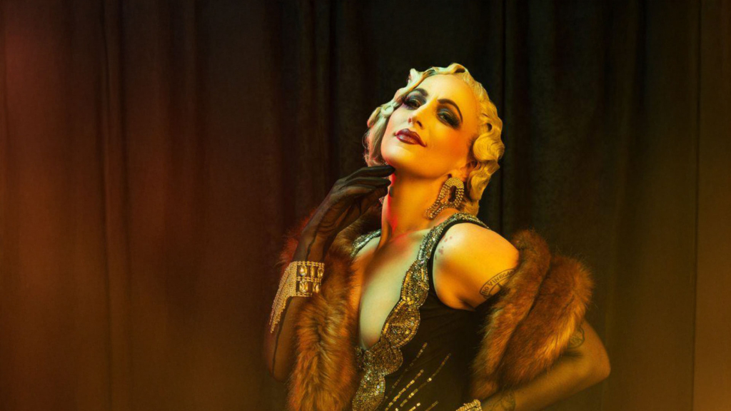 A burlesque performer in glamorous makeup wearing a mink scarf.