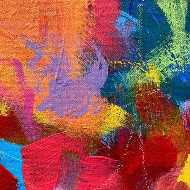 An abstract painting filled with all colours from the rainbow.