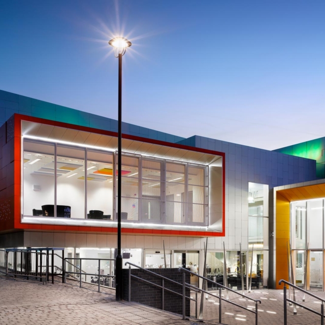 The outside of the Cornerstone building at night.