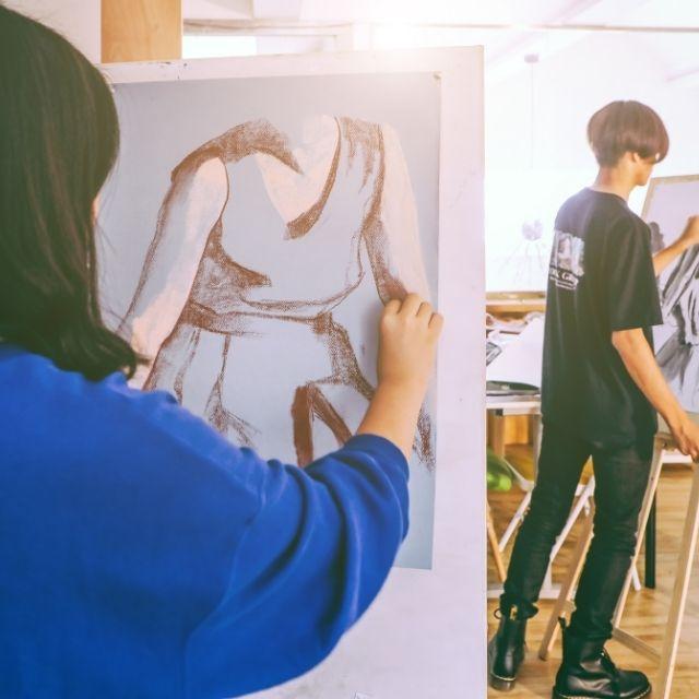 Someone drawing on an easel.