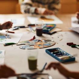 an art table with paints and brushes