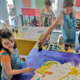 an image of two children painting